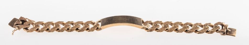 A 9ct gold identity bracelet, the curb links with a textured finish to the outer side,