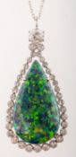 An impressive black opal and diamond halo pendant with chain,