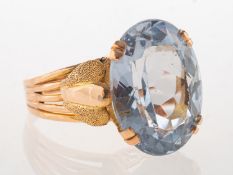 A cocktail ring, claw set with an oval-cut blue synthetic spinel, measuring approx. 18.2mm x 14.