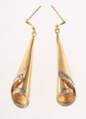 A pair of 9ct gold and diamond drop earrings, of coiled ribbon design,