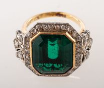 An Art Deco diamond and green paste stone ring, an impressive bi-colour ring,