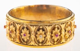 A Victorian diamond and ruby gilt bangle,
