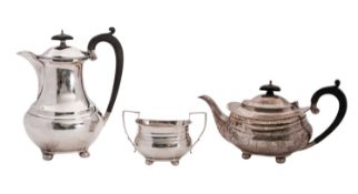 A George V three-piece silver tea set, comprising of hot water jug, tea pot & sugar bowl,