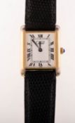 Cartier a gold-plated lady's tank wristwatch the cream rectangular dial having black Roman numerals,