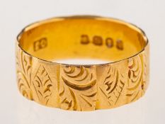 An 18ct gold Victorian wedding band, ornately carved with foliate decoration, UK hallmark, London,