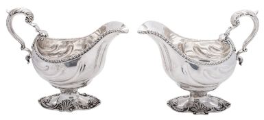 A pair of early George III silver sauce boats, with fluted oval bodies,
