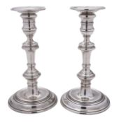 A pair of Elizabeth II silver candlesticks, with knopped stems, spool-shaped capitals,