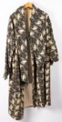 A mid 20th century lady's black and white cotton paisley overcoat with long scarf style wrap over