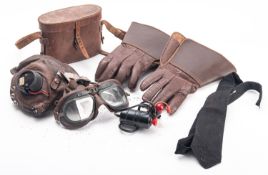 An RAF brown leather flying helmet with goggles, fitted headphones,