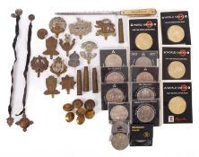 A collection of British regimental cap badges and buttons.