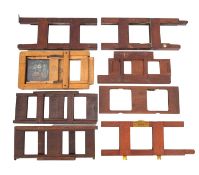 A collection of mostly mahogany magic lantern slide holders.