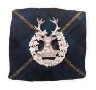 An Officer's Gordon Highlanders silver bonnet badge.