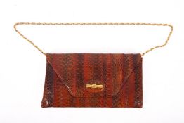 A vintage snakeskin lady's handbag. Having gilt metal strap and fastenings, 17cm high, 29cm wide.