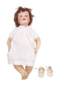 A 20th Century German bisque head doll.