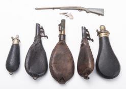 Five leather and leather bound black powder flasks.