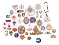A collection of silver and metal badges.