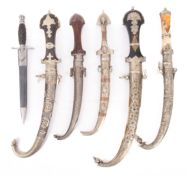 Five Eastern knives with sheaths.