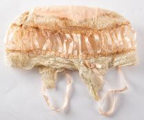 A 19th Century inner silk bonnet. Having pink silk top and foliate lace borders.