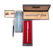 Four ballpoint pens.