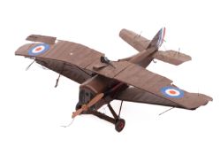 An early 20th century tinplate RFC bi-plane, brown with transfer roundals and black machine gun, 22.