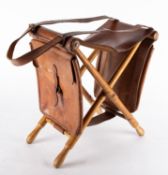 A 20th Century turned oak and leather folding fishing stool.