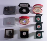 A mixed collection of boxed silver coins.