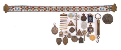 A collection of various lapel and enamel badges,