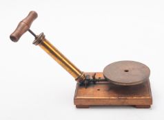 A 20th Century hand vacuum pump, having a turned wooden handle, brass tube and assembly,