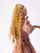 A late 19th century Jumeau automaton doll, the bisque head with applied blonde wig,