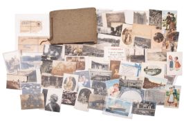 A collection of early 20th Century and later photographs in an album.