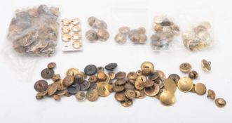 A collection of brass military and sporting related dress buttons.