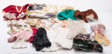 A mixed collection of dolls clothing, comprising dresses, trousers, jackets,