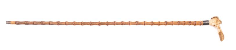 A carved horn and silver mounted walking cane.