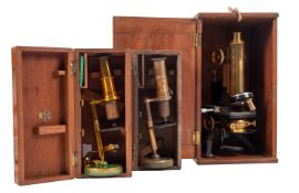 A 20th Century brass microscope in fitted wooden case,