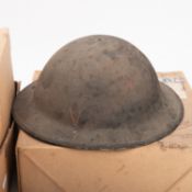 A British MkI steel helmet. Having leather lining and canvas strap, together with a rubber gas mask.