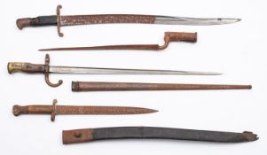 A French M1874 bayonet and scabbard. Together with three other various bayonets.