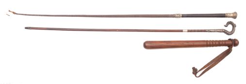 A white metal mounted leather riding crop,