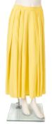 A group of four unlabelled vintage style skirts, including a a bright yellow full skirt,