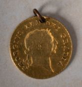 An 1810 George III half guinea (holed).