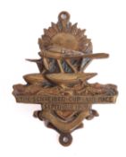 An early 20th century brass Schneider door knocker,