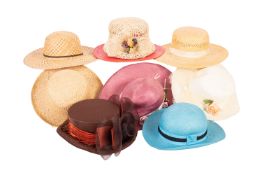 A large collection of various lady's hats, including straw sun hats, felt hats,
