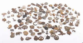 A collection of British regimental cap badges, buttons and insignia,