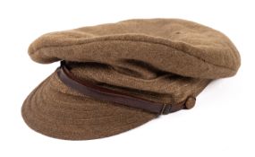 A British WWI M1915 woollen peaked cap. In green with leather chin strap.