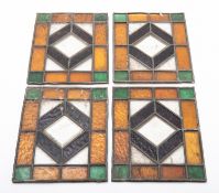 A set of four leaded stained glass panels.