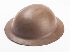 A WWI British MK1 steel helmet unsigned, brown with black and brown leather liner and chin strap.