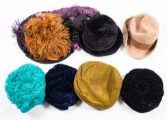 A group of various lady's hats, including paperboy hats, felt hats,