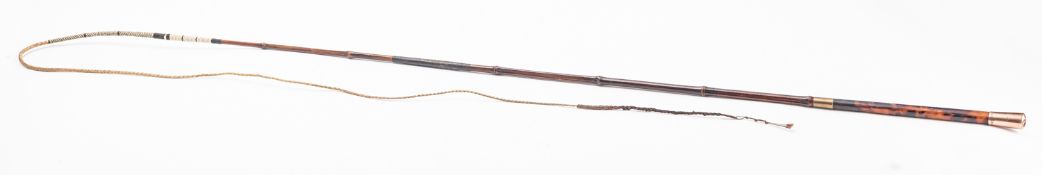 A tortoiseshell and holly driving whip with a 9ct rose gold mounting,