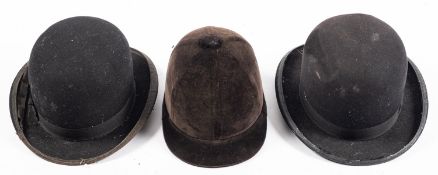 Two black bowler hats, including a 'The Pliable Hat' and another,