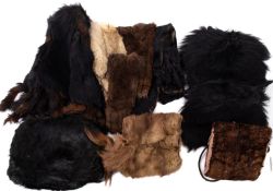 Two pairs of early 20th century lady's fur gloves, together with two fur muffs,