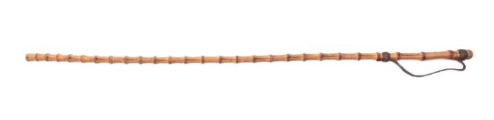 A WWII bamboo Japanese officer's swagger stick. Mounted leather strap to one end, 85cm long.